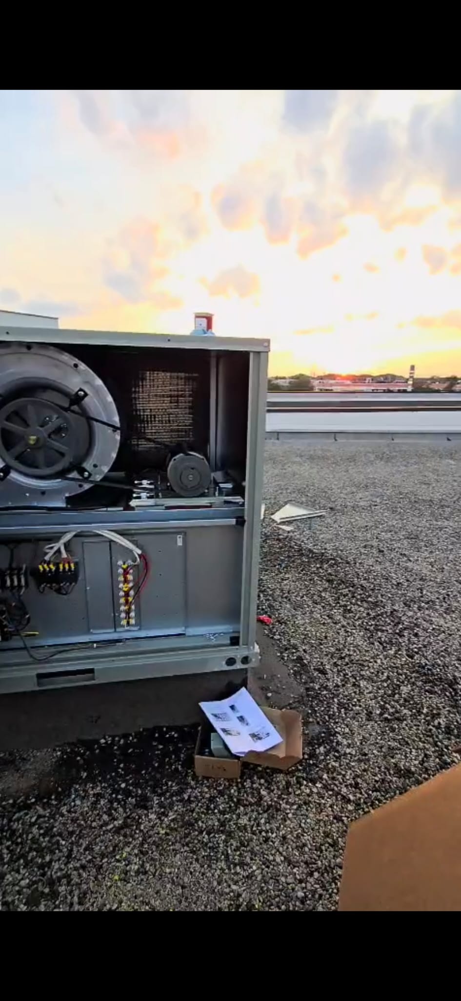 Rooftop HVAC unit at sunset